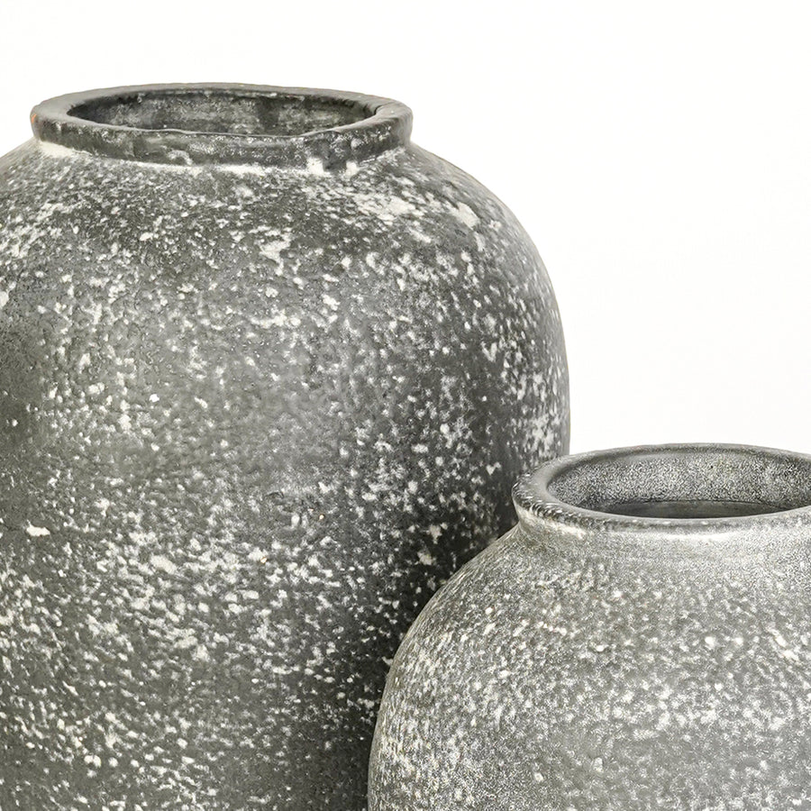 Closeup image of grey ceramic decorative vase set for elegant interior styling with artistic textured finish.