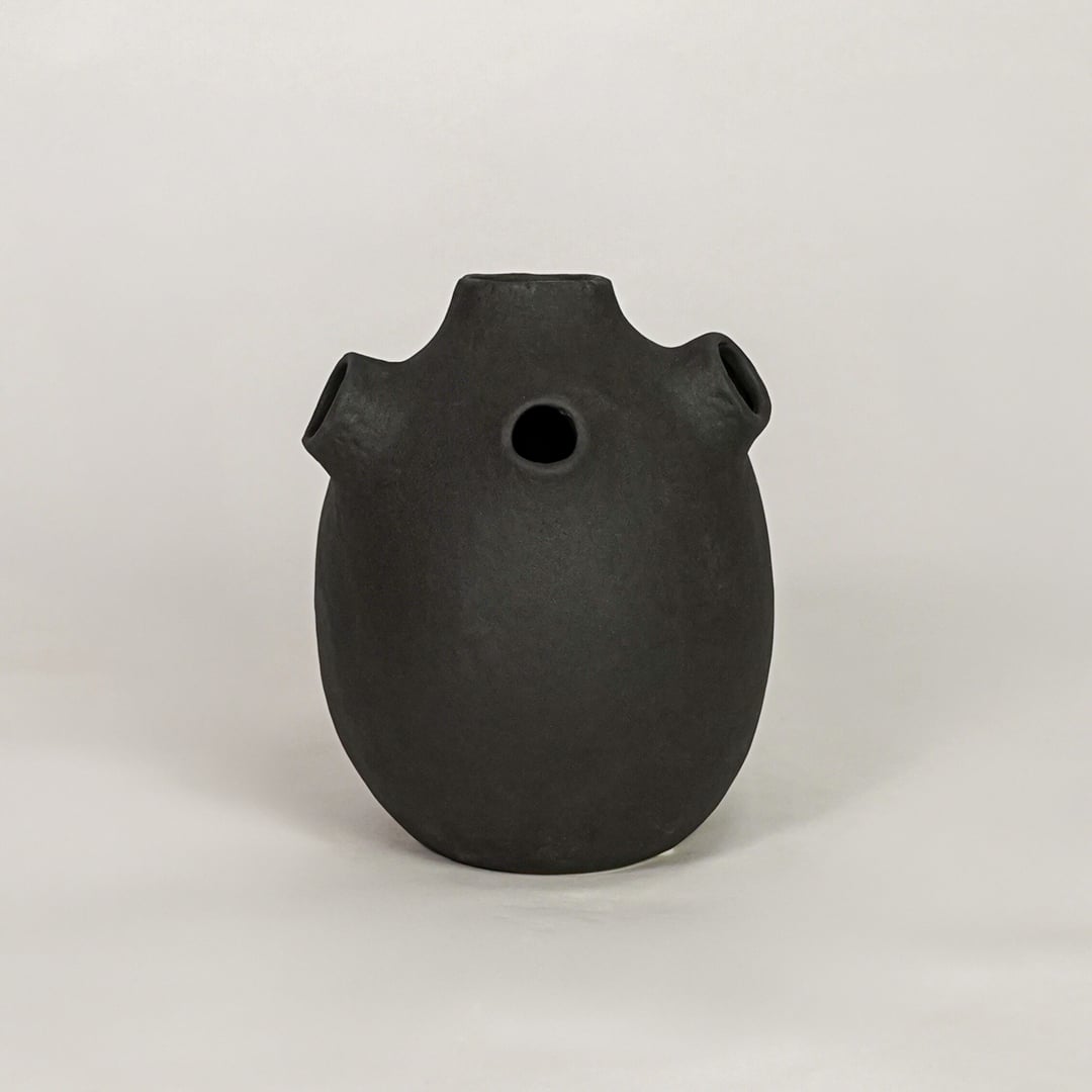 oddball black ceramic vase white background