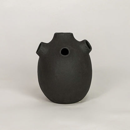 oddball black ceramic vase white background