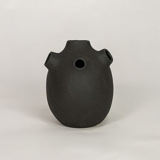 oddball black ceramic vase white background
