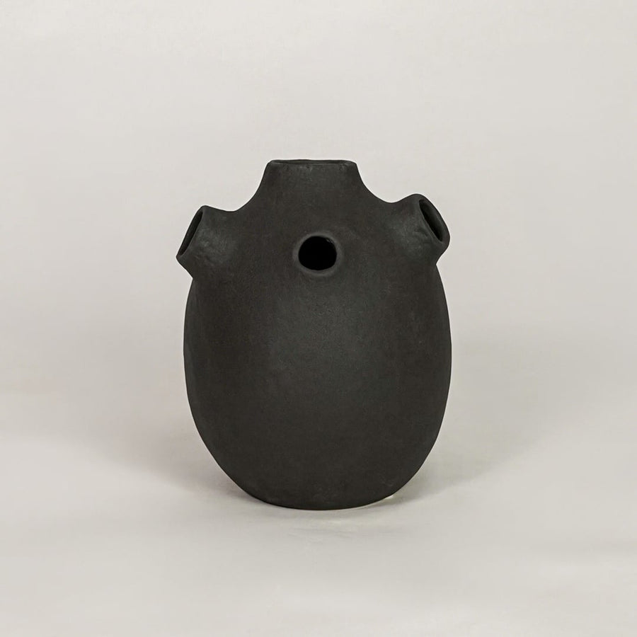 oddball black ceramic vase white background