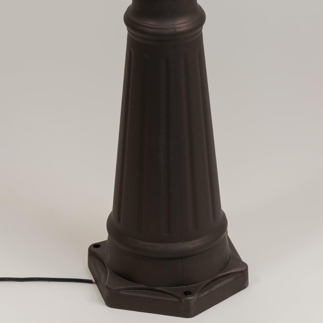 Closeup of black outdoor street lamp base with elegant metal finish for modern exterior decor styling.
