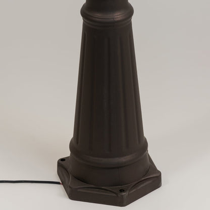 Closeup of black outdoor street lamp base with elegant metal finish for modern exterior decor styling.