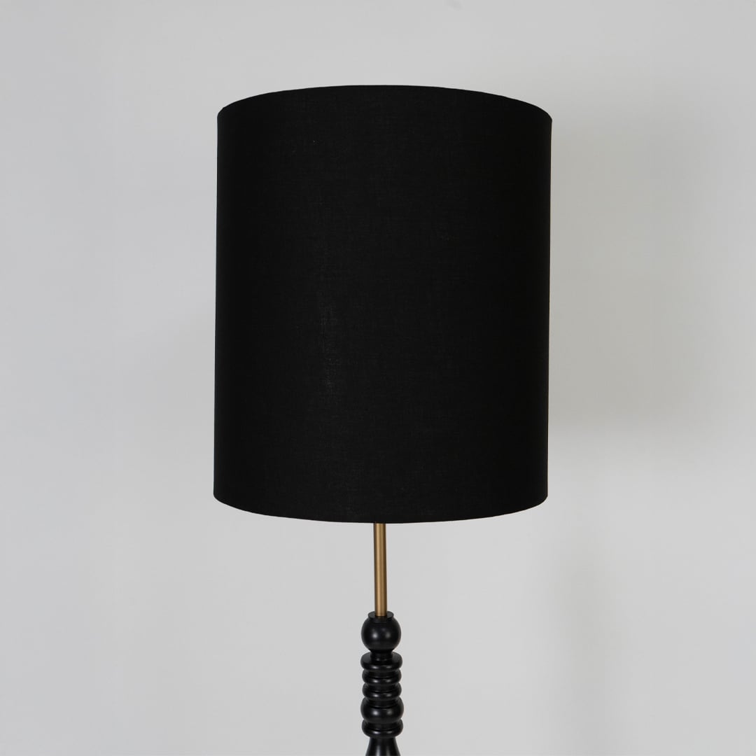 Black fabric drum shade with refined texture highlighting contemporary design and elegant ambient lighting appeal.