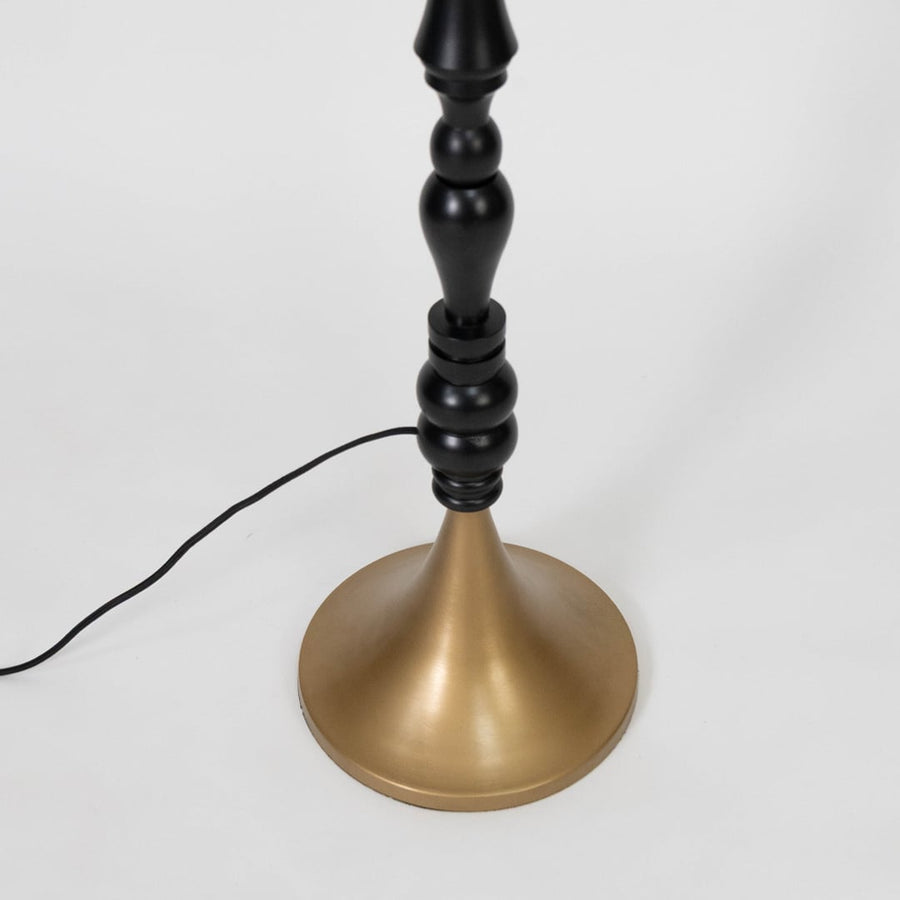 Turned wood floor lamp stem with rich black finish and brass base showcasing timeless craftsmanship and luxury styling.