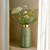 Lifestyle image of olive grey green gold ceramic vase for elegant room decor styling with modern smooth painted finish.