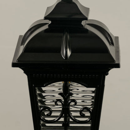 A closeup view of the hanging lantern showing the textured glass and ornate metal detailing with the warm glow inside enhancing the overall aesthetic appeal.