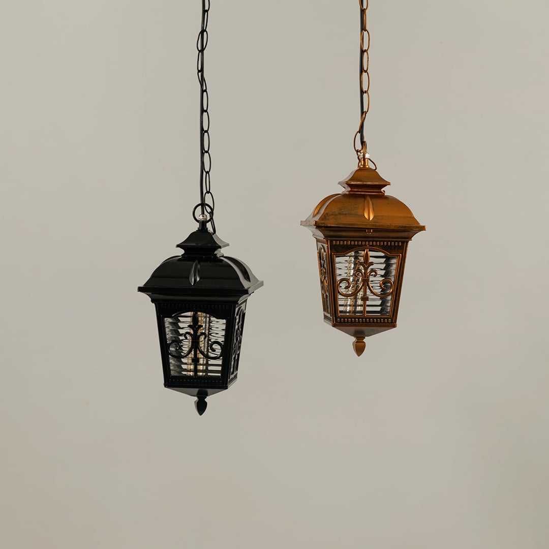 A pair of hanging lanterns with lights off highlighting their ornate frames and textured glass panels showing craftsmanship and design clarity without illumination.