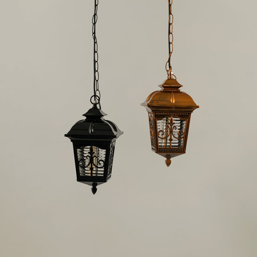 A pair of hanging lanterns with lights off highlighting their ornate frames and textured glass panels showing craftsmanship and design clarity without illumination.