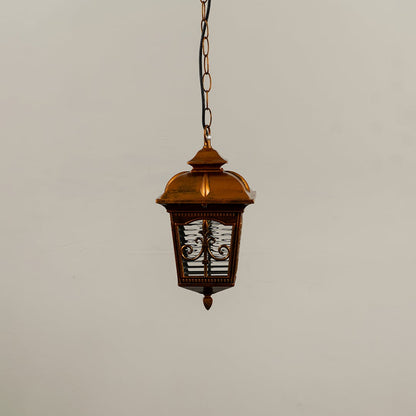 A golden hanging lantern with light off against a white background showing its patterned glass panels and intricately crafted metal frame in clear detail.
