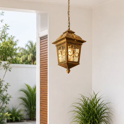 Vintage brass metal outdoor hanging lantern for porch entrance gazebo and covered patio with warm ambient lighting.