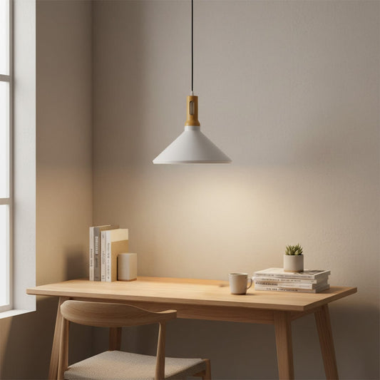 White pendant light with wooden accent hanging above minimal wooden study desk with chair books and coffee cup creating calm focused home workspace.