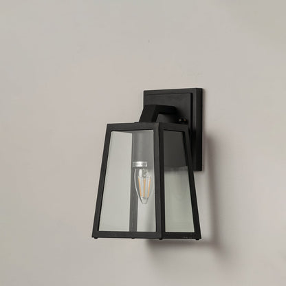 Black metal outdoor wall lantern with geometric frame and clear glass panels displayed on white background for product detailing.