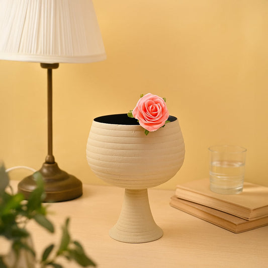 Cream metal pedestal bowl decor placed in a warm modern setting adding an elegant touch to living room tables and shelves.