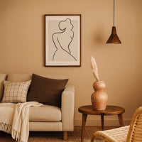 Brown terracotta decorative vase with white polka dots styled in a warm modern room adding artistic earthy decor to living rooms hallways and interiors.