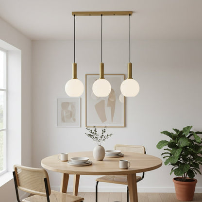 Modern gold and white glass pendant lights adding a clean stylish touch to a bright contemporary room interior.
