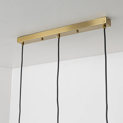 Close view of white globe pendant lights with sleek gold holders showing a smooth modern finish suitable for stylish interior lighting.