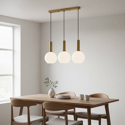 Elegant pendant light trio with white globe shades and gold metal holders hanging from a slim gold bar creating a bright modern room look.