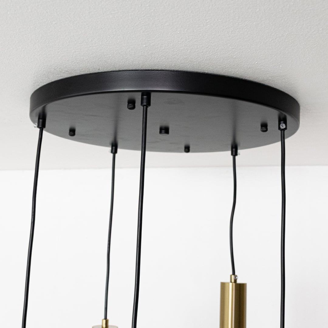 Close view of white globe pendant lights with gold metal holders highlighting their smooth modern finish for stylish interior lighting design.