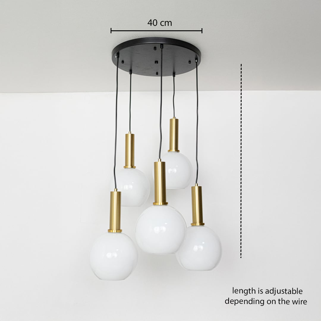 Adjustable five light pendant cluster with white globe shades and gold holders shown with a clear hanging height guide for accurate display.