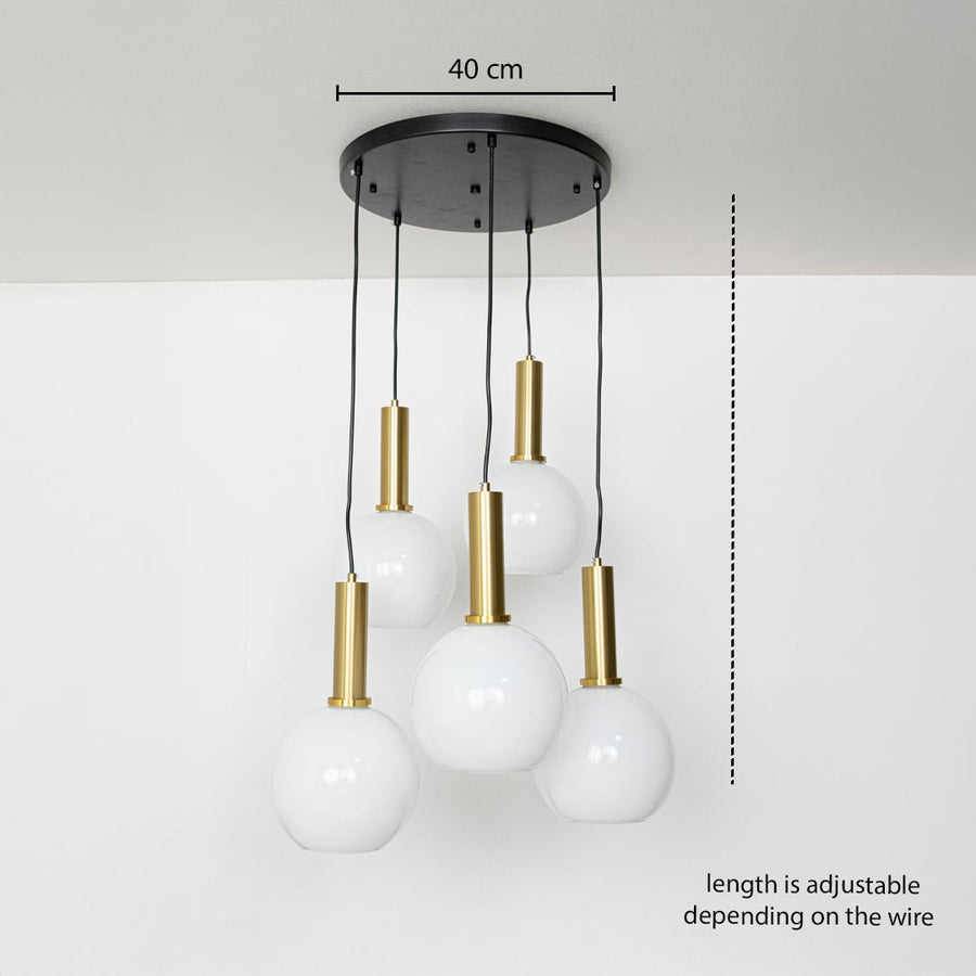 Adjustable five light pendant cluster with white globe shades and gold holders shown with a clear hanging height guide for accurate display.