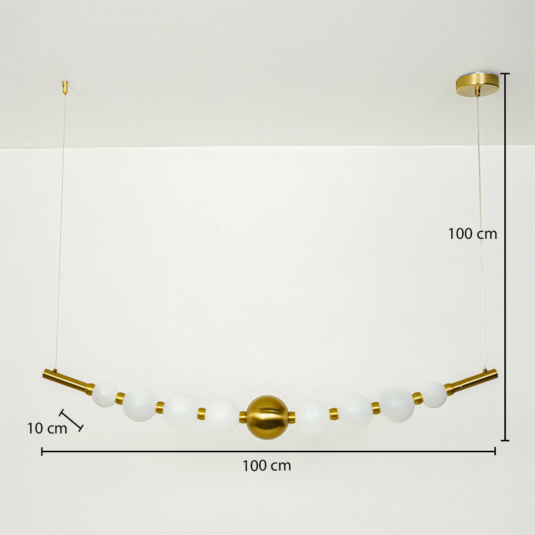 Modern linear pendant light with white glass globes and gold accents suspended on cable 100 cm width 100 cm height 10 cm depth ideal for dining or kitchen lighting.