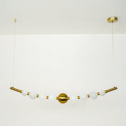 Stylish linear hanging light with multiple white glass globes and gold accents on neutral wall background perfect for modern dining or kitchen lighting.