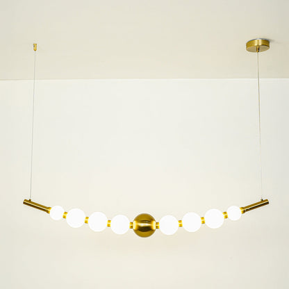 Minimal gold pendant light with white globe shades arranged in linear design on clean neutral background ideal for contemporary home lighting.