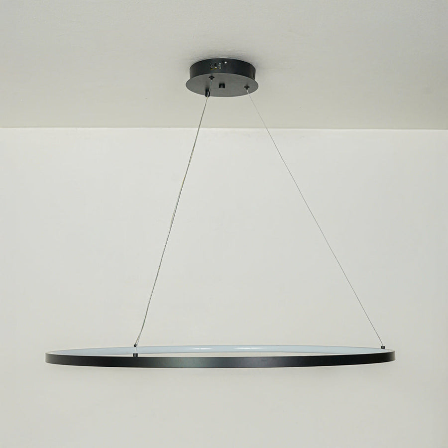 Modern slim black linear pendant light suspended by cables against clean white ceiling background ideal for minimalist kitchen or dining lighting.
