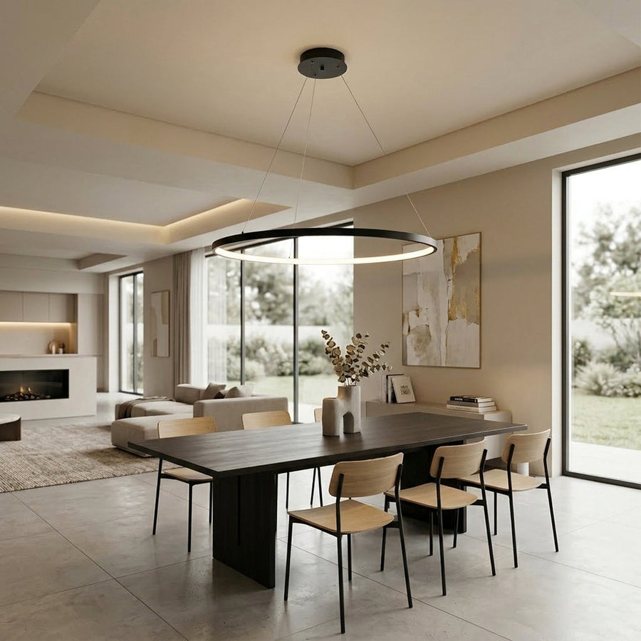 Elegant linear pendant light installed above kitchen island in luxury interior space with warm ambient lighting and modern decor elements.