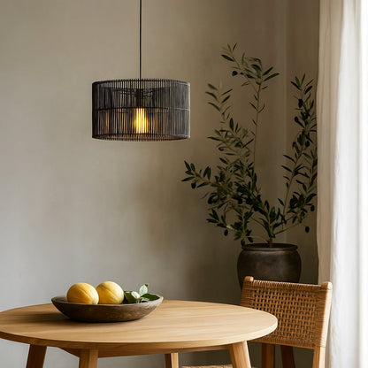 Black cylindrical rattan pendant light enhancing modern interiors with its handcrafted weave and soft warm ambient illumination.