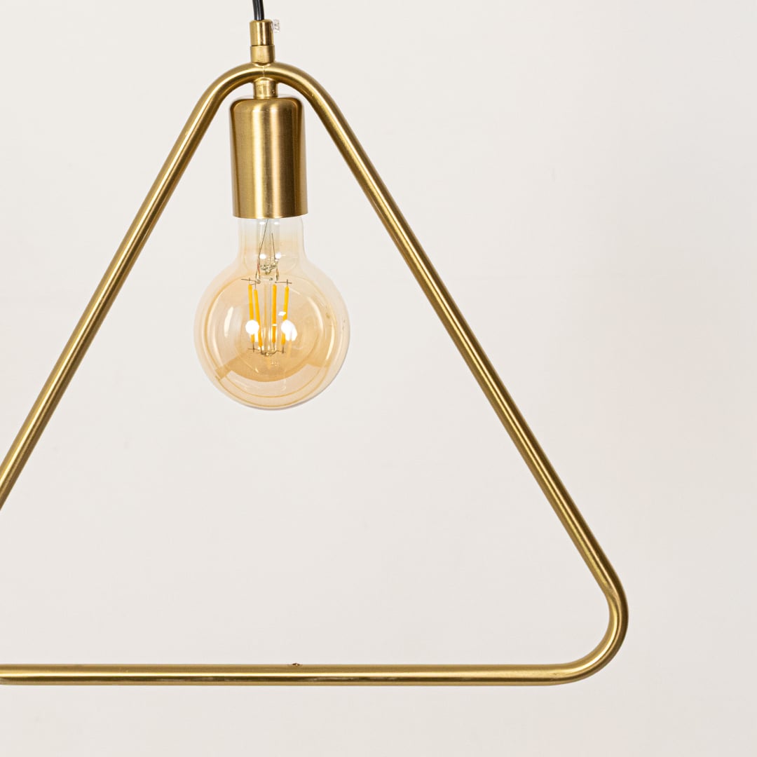 Closeup of gold metal triangle pendant light highlighting sleek frame and premium craftsmanship.