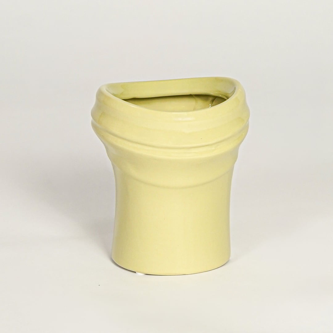 Minimal yellow ceramic decor vase with rounded shape and polished surface designed for tabletop floral arrangements.