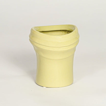 Minimal yellow ceramic decor vase with rounded shape and polished surface designed for tabletop floral arrangements.