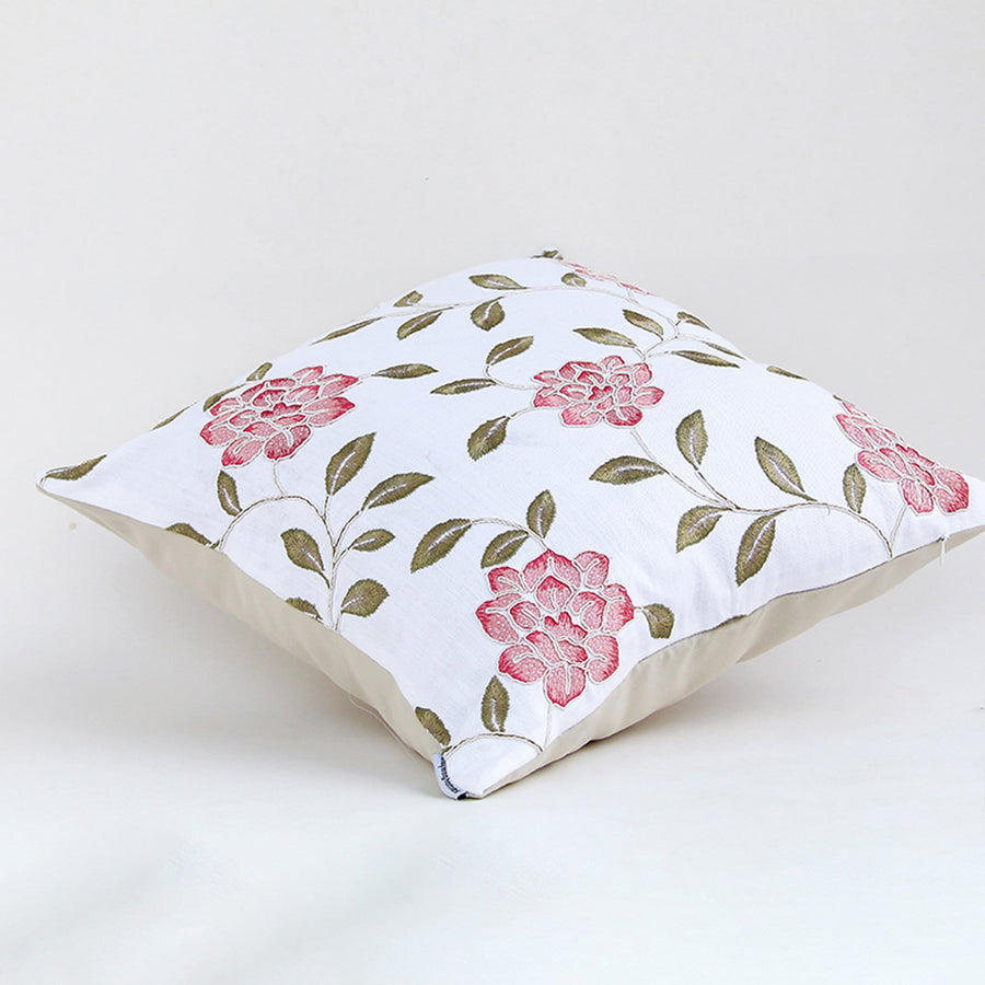 Side view of floral cushion cover with pink rose print leafy accents and soft fabric ideal for sofa decor use.