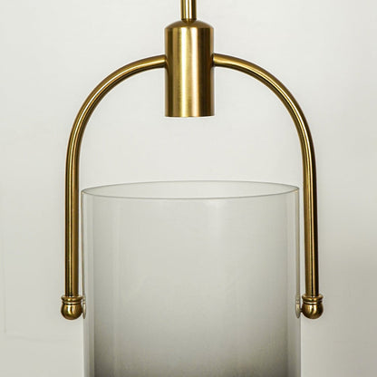 Detailed view of white frosted glass pendant light with curved gold frame and premium finish.