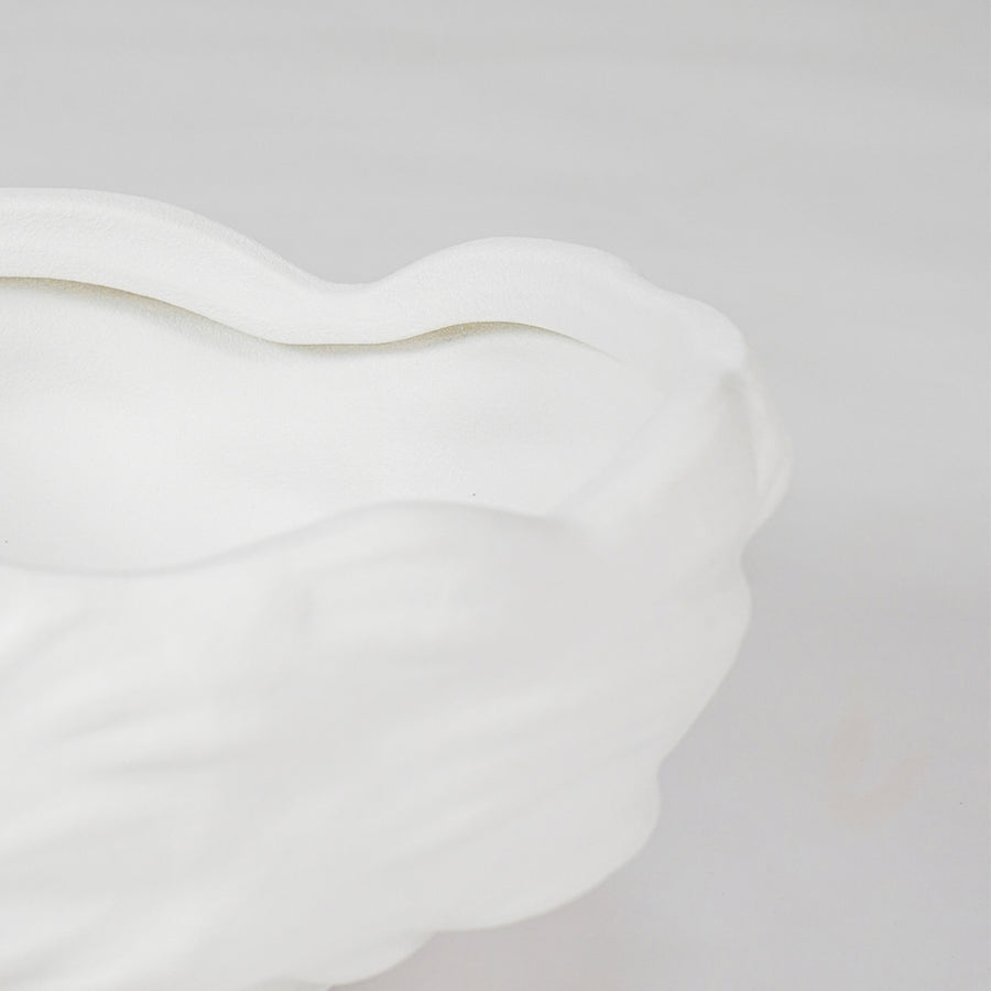 Closeup image of white ceramic abstract bowl for modern dining table styling with smooth artistic matte finish.