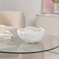 White textured ceramic planter bowl placed on glass table for stylish modern living room decor styling.
