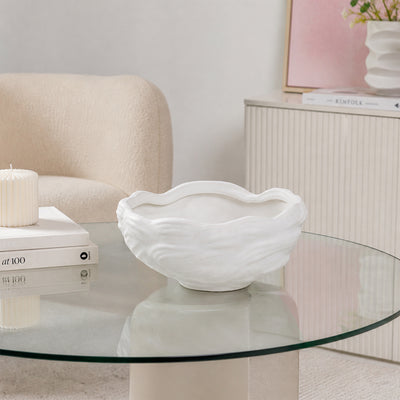 White textured ceramic planter bowl placed on glass table for stylish modern living room decor styling.