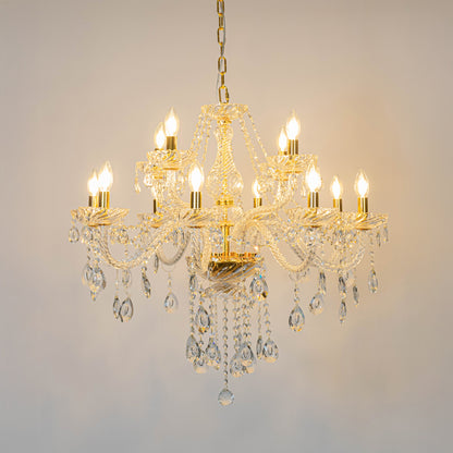 Gold crystal chandelier with illuminated candle bulbs and cascading crystal accents creating luxurious classic ceiling lighting.