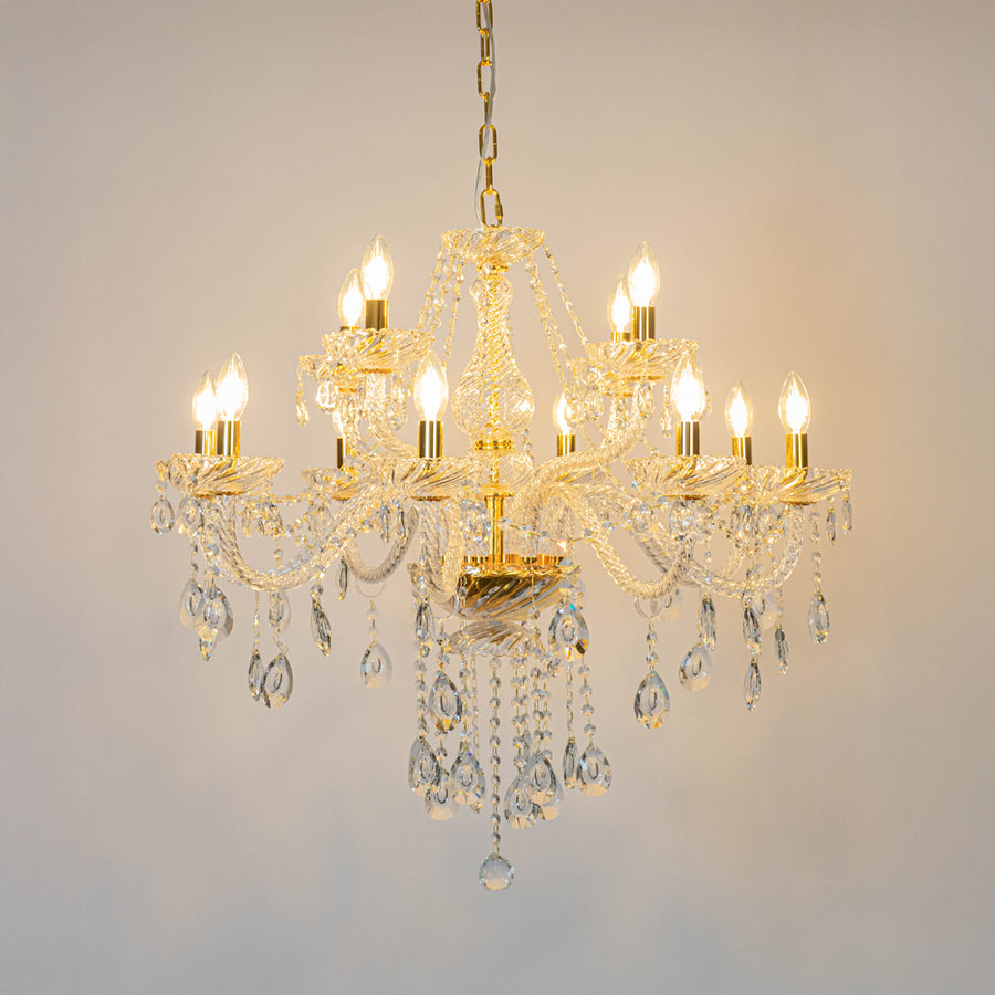Gold crystal chandelier with illuminated candle bulbs and cascading crystal accents creating luxurious classic ceiling lighting.