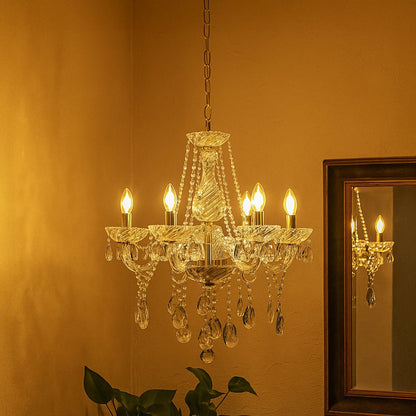 Crystal chandelier with gold accents glowing warmly in living room corner with mirror reflection for decor.