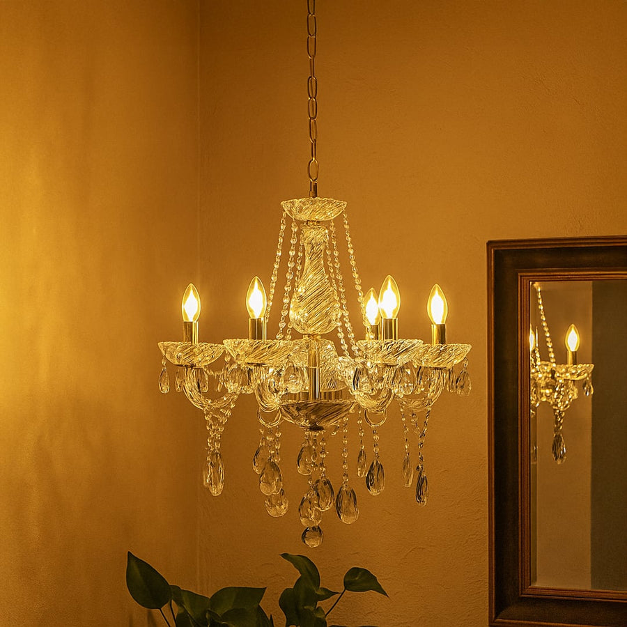 Crystal chandelier with gold accents glowing warmly in living room corner with mirror reflection for decor.