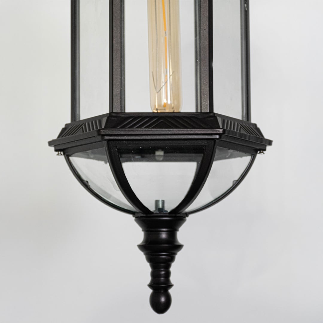 Detailed closeup of black metal outdoor lantern with glass panels highlighting traditional craftsmanship and premium finish.