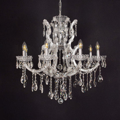 Crystal glass chandelier with chrome accents displayed on black background creating a dramatic elegant decor vibe.