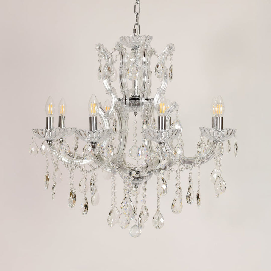 Crystal glass chandelier with chrome finish shown on white background for stylish modern home decor inspiration.