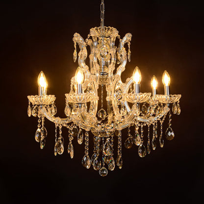 Crystal chandelier glowing against black background with chrome accents highlighting luxury interior lighting style.