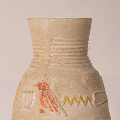 Close-up of small hieroglyph vase revealing hand-engraved Egyptian symbols and subtle glaze details.