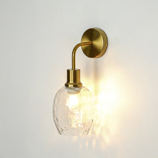 Modern gold metal wall light glowing on white wall for stylish bedroom hallway and living room decor styling.