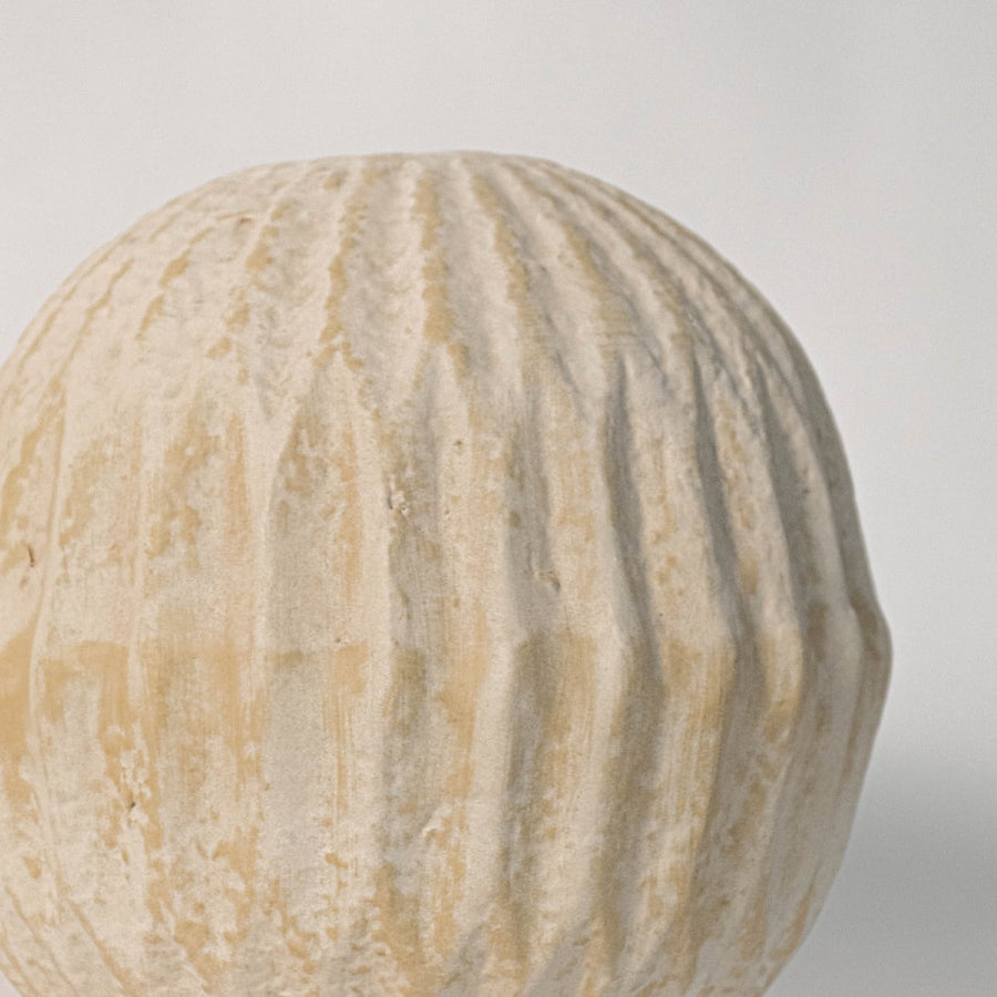 Close up of round textured vase revealing detailed ribbed pattern and fine handmade ceramic texture.